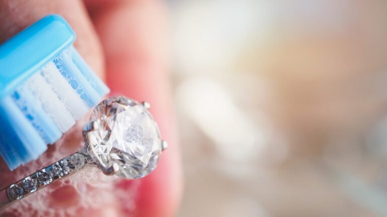 Diamond ring being cleaned with a toothbrush and soapy water